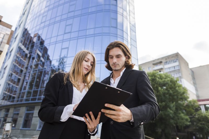 man-woman-looking-clipboard